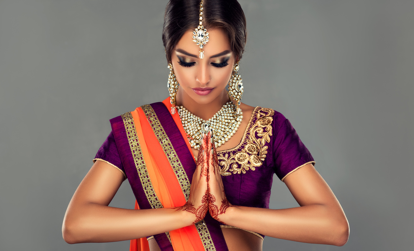 Attractive Indian woman is demonstrating welcome gesture-namaste. Oriental beauty.