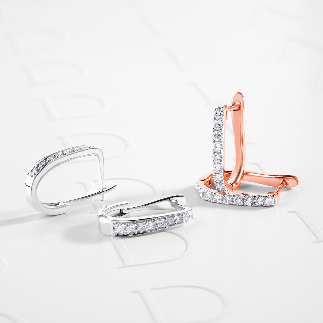 Diamond Earrings on White Surface